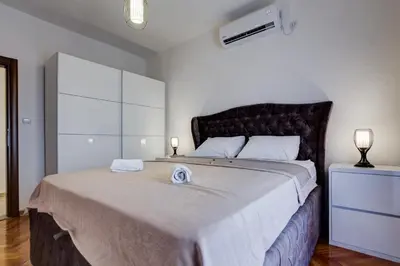 a bedroom with a large bed with two towels on it at Villa Mina in Kotor