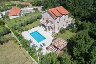 an aerial view of a house with a swimming pool at Villa Mina in Kotor