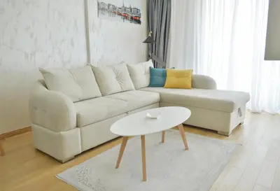 a living room with a white couch and a table at Apartment Old Town Budva in Budva