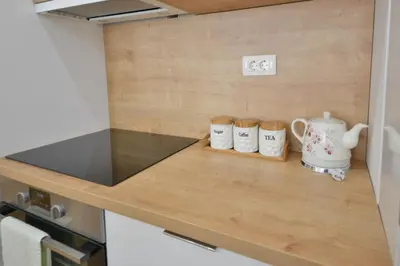 a kitchen counter with three coffee mugs on it at Apartment Old Town Budva in Budva