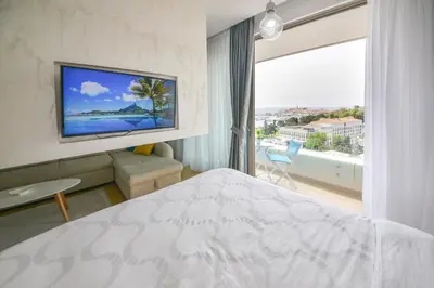 a hotel room with a bed and a large window at Apartment Old Town Budva in Budva