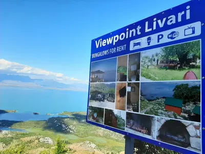 a sign for a viewpoint library with a view of the ocean at Livari Viewpoint in Livari