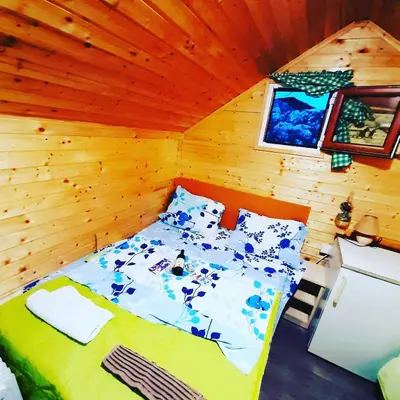 a bedroom with a bed in a wooden cabin at Livari Viewpoint in Livari