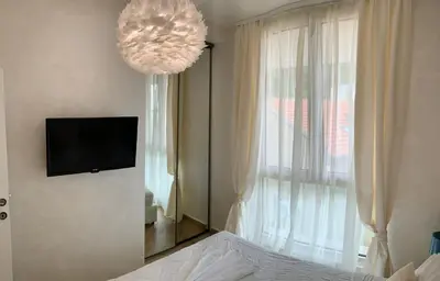 a bedroom with a mirror and a tv on the wall at Butterfly Apartman in Rafailovici