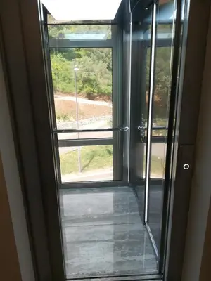 an open door with a window in a room at Butterfly Apartman in Rafailovici