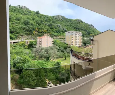 a balcony with a view of a mountain at Butterfly Apartman in Rafailovici