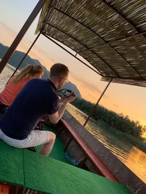 a man and a woman sitting on a roller coaster at Ethno village Moraca - Skadar lake in Vranjina