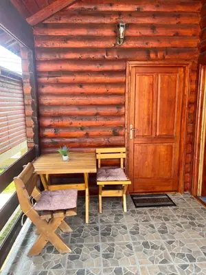 a wooden room with a table and two chairs and a door at Ethno village Moraca - Skadar lake in Vranjina