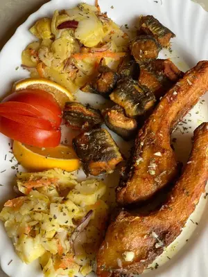 a white plate of food with sausage and vegetables at Ethno village Moraca - Skadar lake in Vranjina