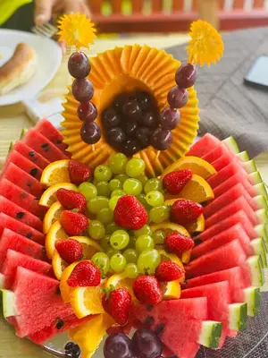 a plate of fruit with grapes strawberries and oranges at Ethno village Moraca - Skadar lake in Vranjina