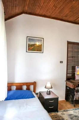 a bedroom with a bed and a table with a lamp at Holiday Home Milanovic in Cetinje