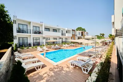 an outdoor swimming pool with lounge chairs and a hotel at Hotel Halibas in Ulcinj