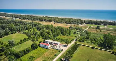 an aerial view of a house and the ocean at Hotel Halibas in Ulcinj