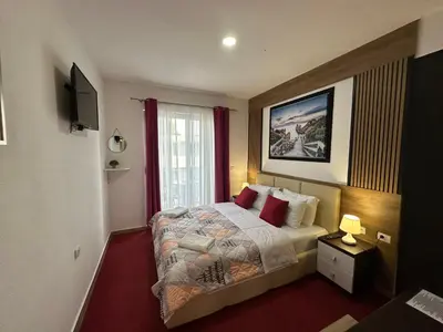 a hotel room with a bed and a window at Hotel Halibas in Ulcinj