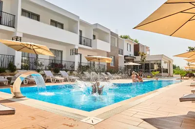 a swimming pool with a fountain in a building at Hotel Halibas in Ulcinj