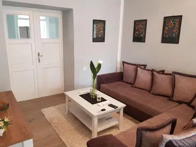 a living room with a couch and a coffee table at Harmony cozy home in Podgorica