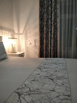 a bedroom with a large bed with a marble at Harmony cozy home in Podgorica