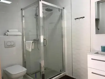 a bathroom with a shower with a toilet and a sink at First line of the sea 1 in Dobra Voda