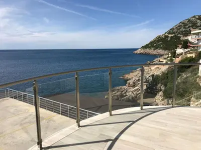 a balcony with a view of the ocean at First line of the sea 1 in Dobra Voda