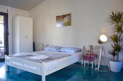 a bedroom with a white bed with blue floors at Baraka in Ulcinj