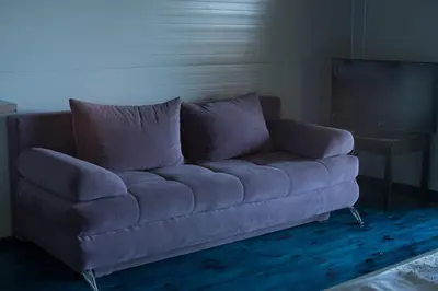 a blue couch in a living room with a television at Baraka in Ulcinj