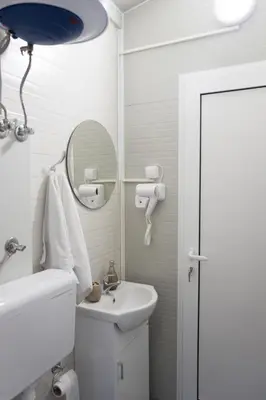 a white bathroom with a sink and a mirror at Baraka in Ulcinj