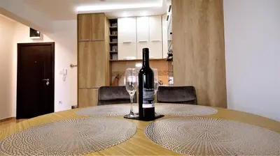 a bottle of wine sitting on a table with a glass at Aleksa Lux apartment Budva in Budva