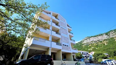 a building with a car parked in front of it at Aleksa Lux apartment Budva in Budva