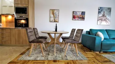 a living room with a table and chairs and a couch at Aleksa Lux apartment Budva in Budva