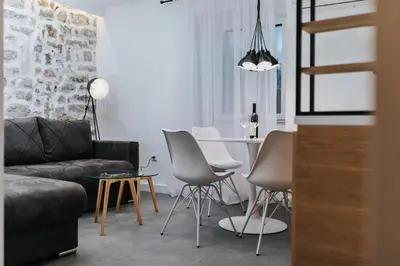 a living room with a couch and a table and chairs at Apartments Trifunovic Old Town in Budva