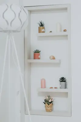 a room with white shelves with potted plants at Apartments Trifunovic Old Town in Budva