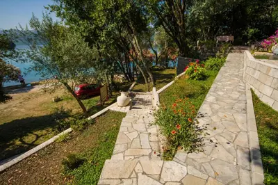 a garden with flowers and a stone walkway at Seaside Story in Tivat