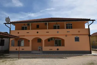 a large orange house with arrows on it at Vila Cattleya in Donji Štoj
