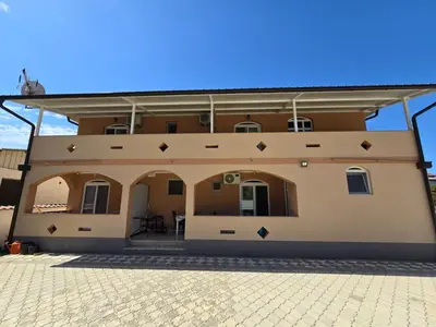 a large house with a roof on top of it at Vila Cattleya in Donji Štoj