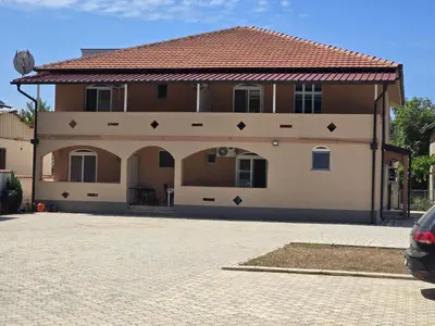 a house with a car parked in front of it at Vila Cattleya in Donji Štoj