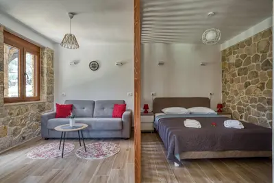 a living room with a bed and a couch at Stonehouse in Olives in Ulcinj