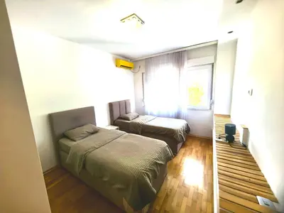 a bedroom with two beds and a window at Luxury apartment Podgorica in Podgorica