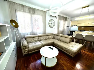 a living room with a couch and a table at Luxury apartment Podgorica in Podgorica