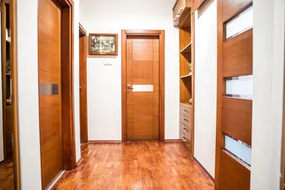a hallway with wood floors and a door at Luxury apartment Podgorica in Podgorica