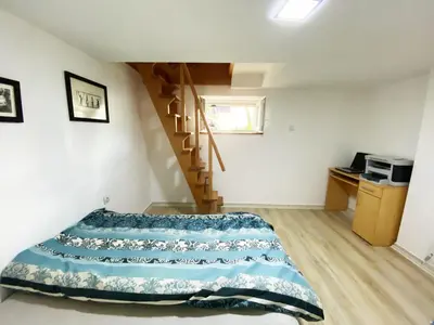 a bedroom with a bed and a spiral staircase at Luxury apartment Podgorica in Podgorica