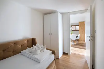 a bedroom with a couch and a dining room at Villa Lazy Hill in Budva