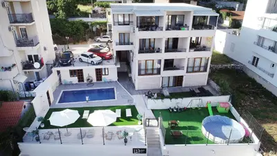 an aerial view of a building with a swimming pool at Villa Lazy Hill in Budva