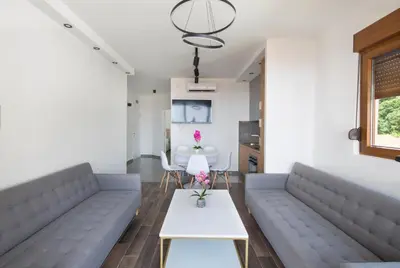 a living room with two couches and a table at Villa Lazy Hill in Budva