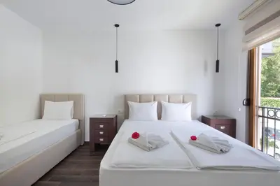 a bedroom with two beds with red roses on them at Villa Lazy Hill in Budva