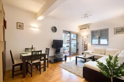 a living room with a couch and a dining room at LORDOR Apartment in Budva