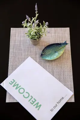 a paper with a fish on a table with a plant at LORDOR Apartment in Budva