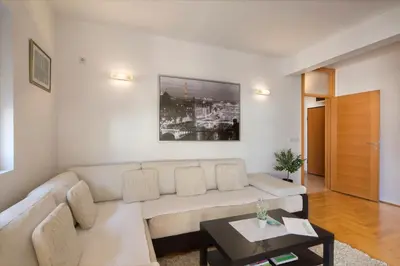a living room with a couch and a table at LORDOR Apartment in Budva