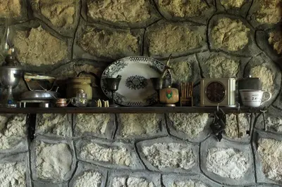 a shelf on a stone wall with items on it at Rent House Orahovo in Virpazar