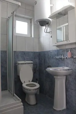 a bathroom with a toilet and a sink at Vila AKI-KA in Sutomore