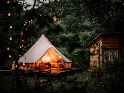 a tent with lights on it in a yard at Hoopoe Glamping in Virpazar